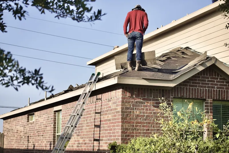 Professional roofer working on a residential roof in Cloverberry